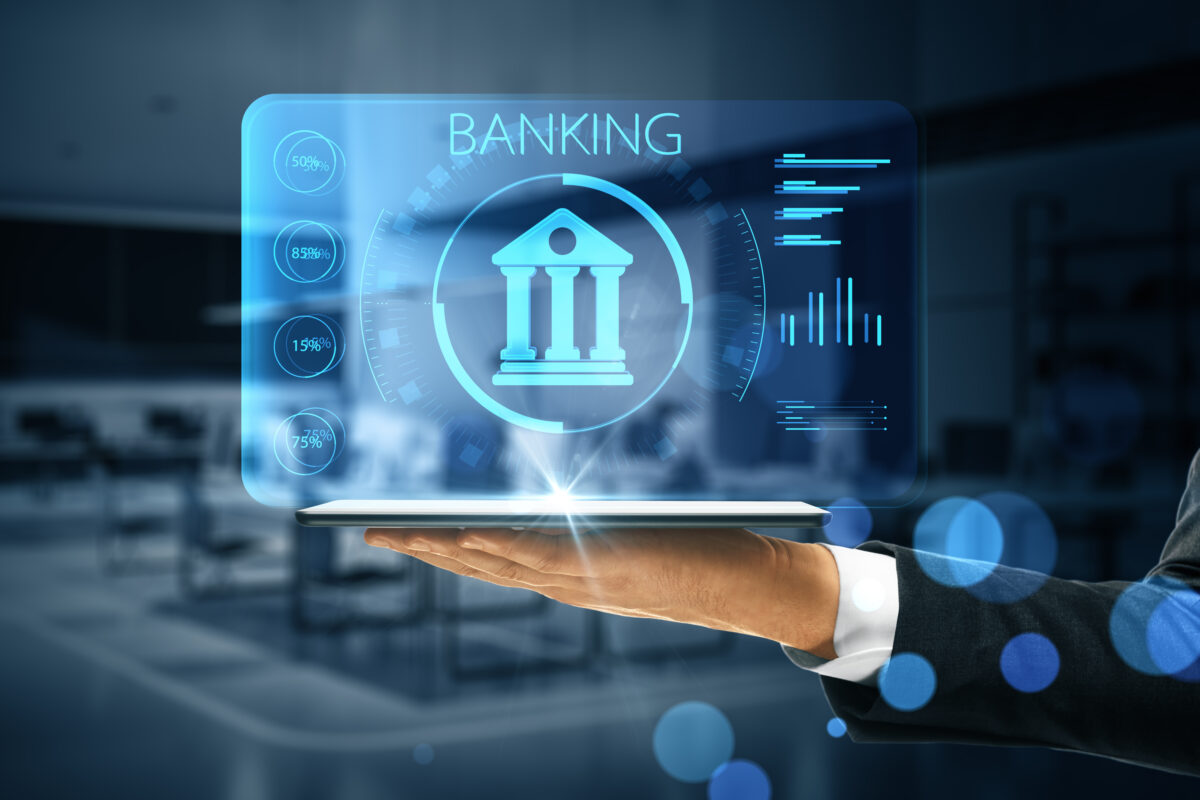 Online banking application concept with digital bank building sign with indicators on virtual projection from digital tablet on man hand